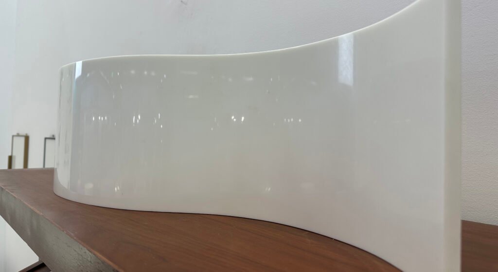 Icon showing the thermoforming capability of SINOCARE artificial marble, illustrating its ability to be hot-bended into seamless curves.